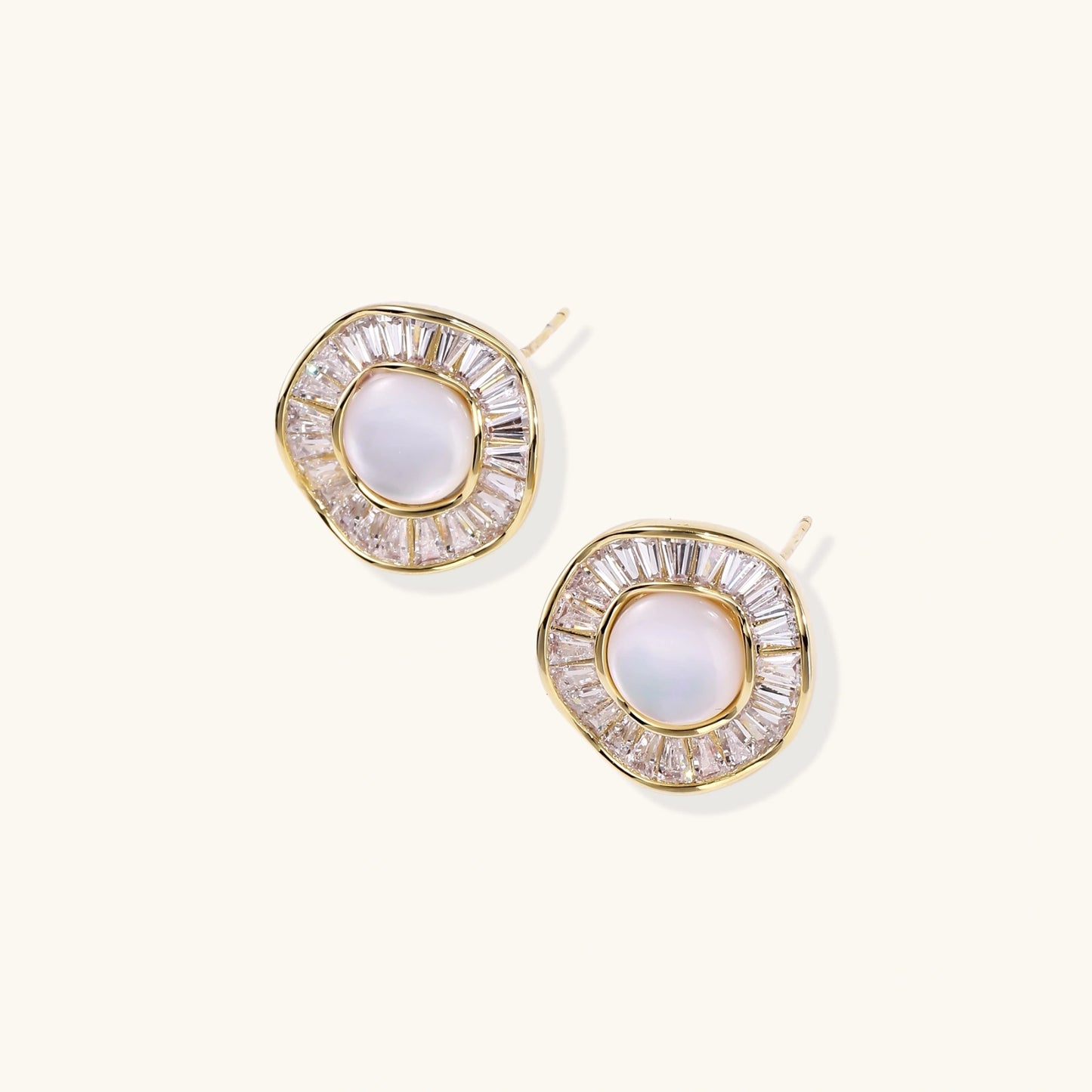 Gold-plated stud earrings with central freshwater pearl surrounded by radiating baguette crystals in sunburst design